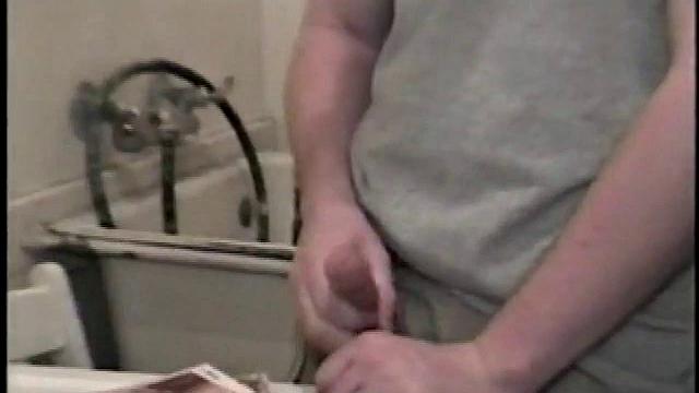 Boy-next-door spreads his new straight porn magazine on top of the washing machine and pulls his cock out of the fly.
