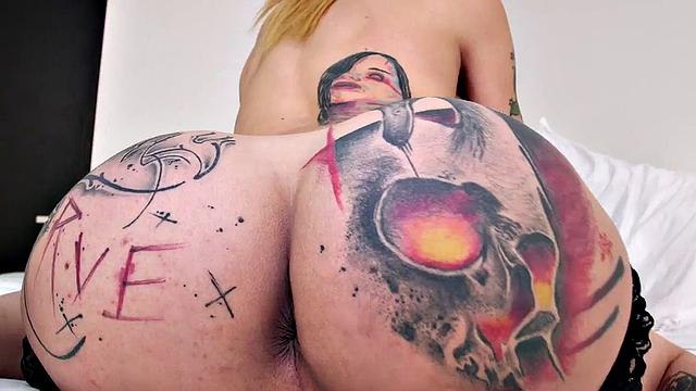 Watch this tattooed blonde bombshell tease and jerk off in lingerie