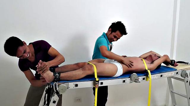 Gay Asian tickle fetish boy Jeff returns for some tickling fun on the rack. Gil and Argie are the sadistic ticklers that deliver hysterical laughter through their fingers and out of Jeff's wide open mouth.