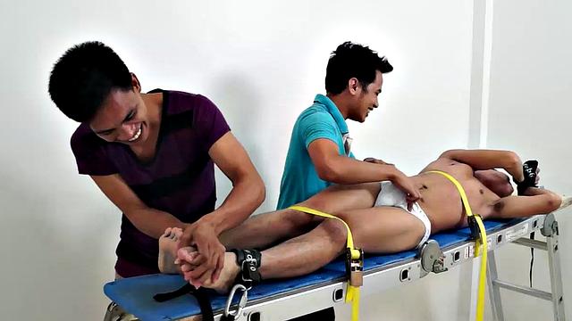 Gay Asian tickle fetish boy Jeff returns for some tickling fun on the rack. Gil and Argie are the sadistic ticklers that deliver hysterical laughter through their fingers and out of Jeff's wide open mouth.