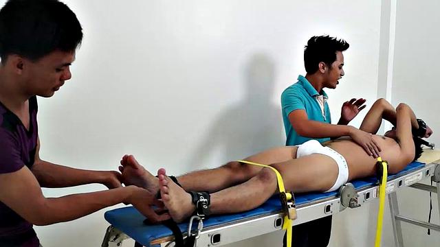 Gay Asian tickle fetish boy Jeff returns for some tickling fun on the rack. Gil and Argie are the sadistic ticklers that deliver hysterical laughter through their fingers and out of Jeff's wide open mouth.