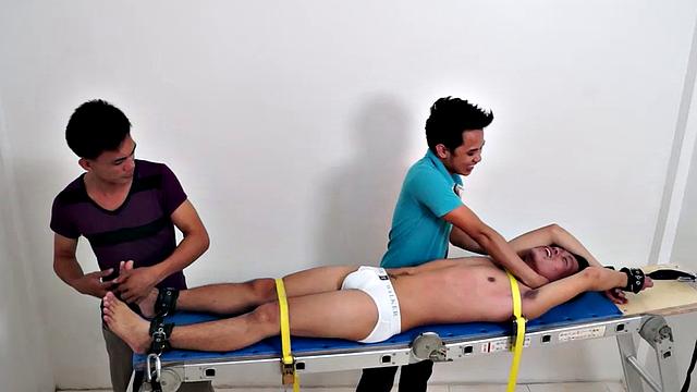Gay Asian tickle fetish boy Jeff returns for some tickling fun on the rack. Gil and Argie are the sadistic ticklers that deliver hysterical laughter through their fingers and out of Jeff's wide open mouth.