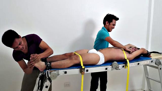 Gay Asian tickle fetish boy Jeff returns for some tickling fun on the rack. Gil and Argie are the sadistic ticklers that deliver hysterical laughter through their fingers and out of Jeff's wide open mouth.