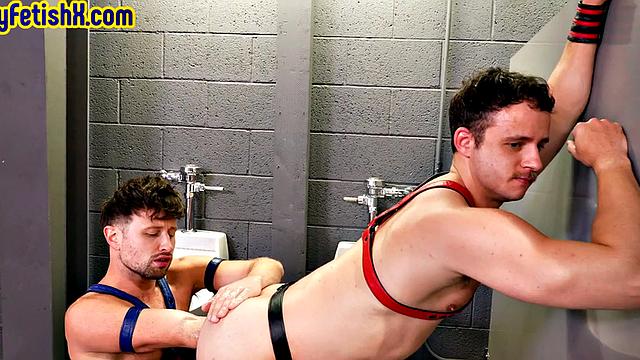 Fisting stud sucks and fists leather BF in toilet