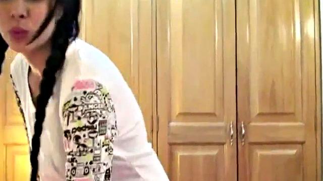 A kinky brunette tease herself with pigtails in the bedroom