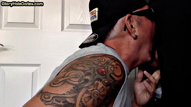 Inked gloryhole DILF sucks cock till jizz in mouth