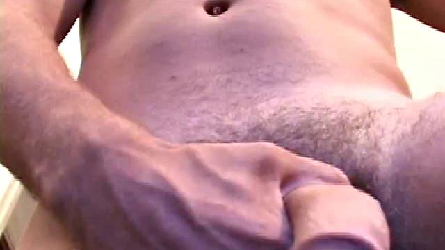 Handsome stud strokes his thick cock and shoots two loads for the camera