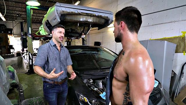 Tattooed stud in the ass fucks muscular nympho in a bareback garage doggystyle