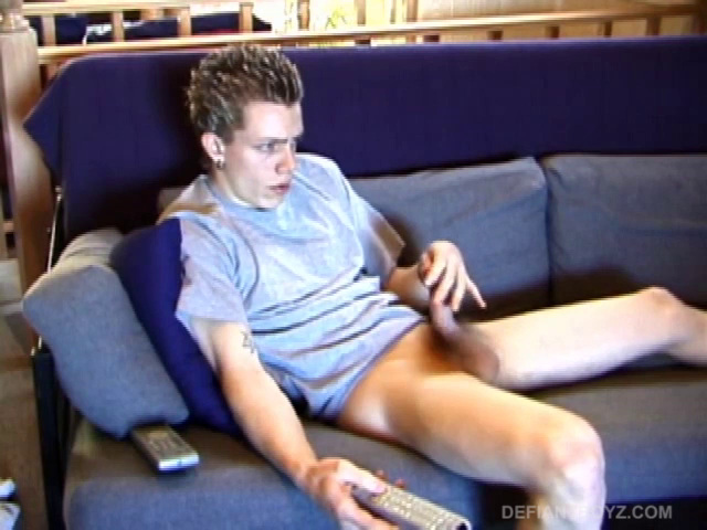 Shane relaxes on the couch, while watching a porn video and gets totally into himself. He works his lubed up cock with determination and pumps out a big cum shot.