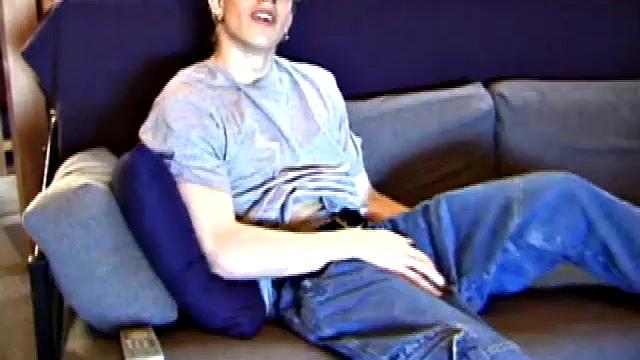 Shane relaxes on the couch, while watching a porn video and gets totally into himself. He works his lubed up cock with determination and pumps out a big cum shot.