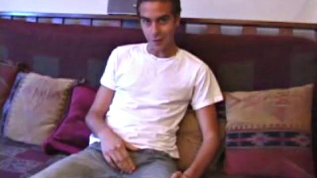 Vincenzo shows off his new purchase, strokes his cock, and uses a sex toy on the couch