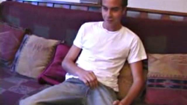 Vincenzo shows off his new purchase, strokes his cock, and uses a sex toy on the couch