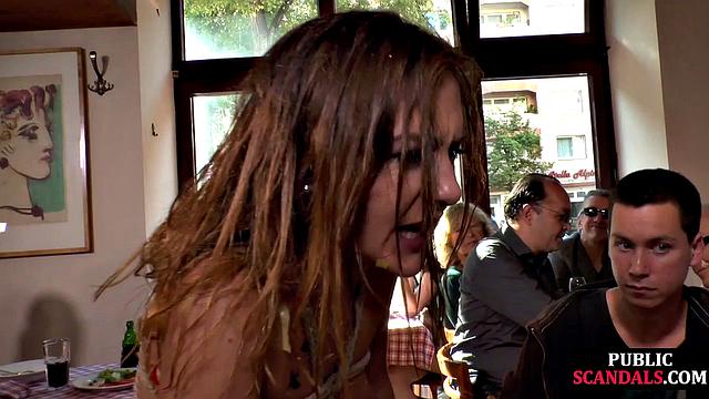 Tied chick giving head in public café