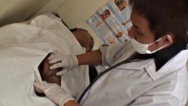 Asian stud gets a thorough check-up before being bred by medic in uniform