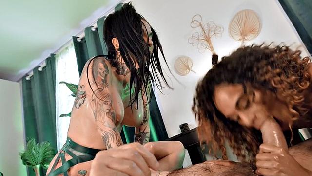 Curly-haired ebony and tattooed MILF get their big tits oiled up & fucked in a hot 3way