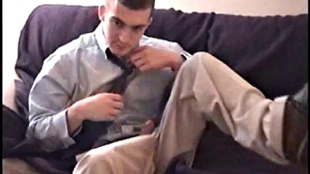 Darrell kicks back on the sofa, makes himself comfortable, rubs his package to work up a bulge, and then releases a big cock. At the same time, he pulls off his dress shirt and tie.