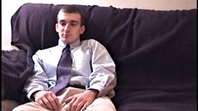 Darrell kicks back on the sofa, makes himself comfortable, rubs his package to work up a bulge, and then releases a big cock. At the same time, he pulls off his dress shirt and tie.