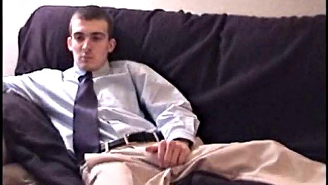 Darrell kicks back on the sofa, makes himself comfortable, rubs his package to work up a bulge, and then releases a big cock. At the same time, he pulls off his dress shirt and tie.