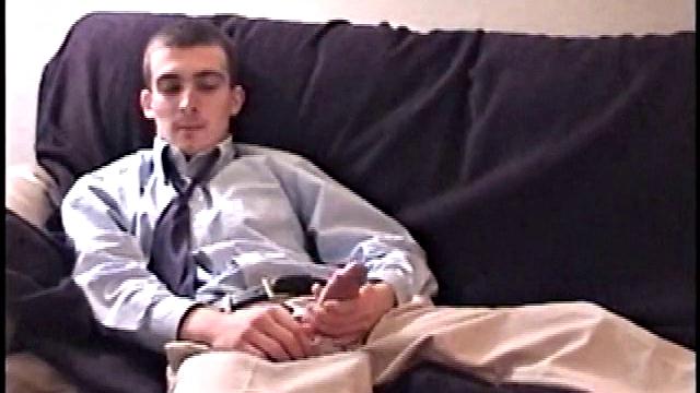 Darrell kicks back on the sofa, makes himself comfortable, rubs his package to work up a bulge, and then releases a big cock. At the same time, he pulls off his dress shirt and tie.