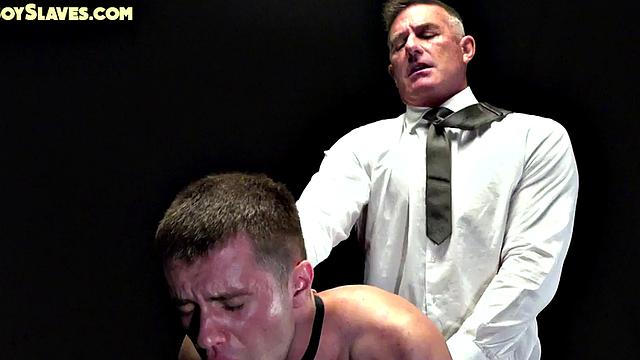 Oiled gay sub dominated by suited DILF in barebacking