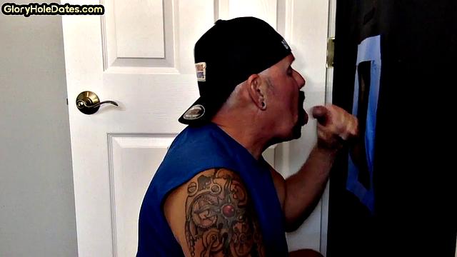 Gloryhole tattooed DILF sucks cock for load in amateur BJ video