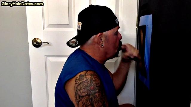 Gloryhole tattooed DILF sucks cock for load in amateur BJ video