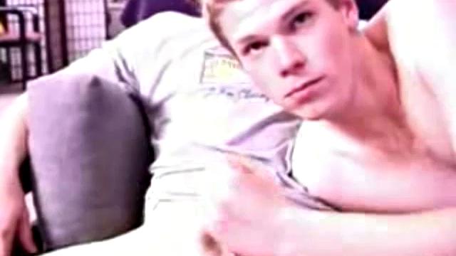 Adam and Christian sit next to each other on the couch watching a porno. They unzip and stoke for a bit, before taking turns sucking each other's hard cock.