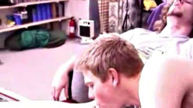 Adam and Christian sit next to each other on the couch watching a porno. They unzip and stoke for a bit, before taking turns sucking each other's hard cock.