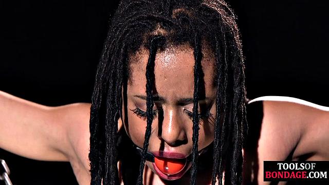 Mouthgagged ebony babe toyed