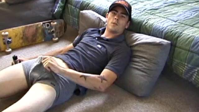 Dan gets down on the floor and starts watching a porn video. He goes right for his cock and plays with himself until he's boned up. Rolling the head with his palm, Dan lubes up his hot dick.