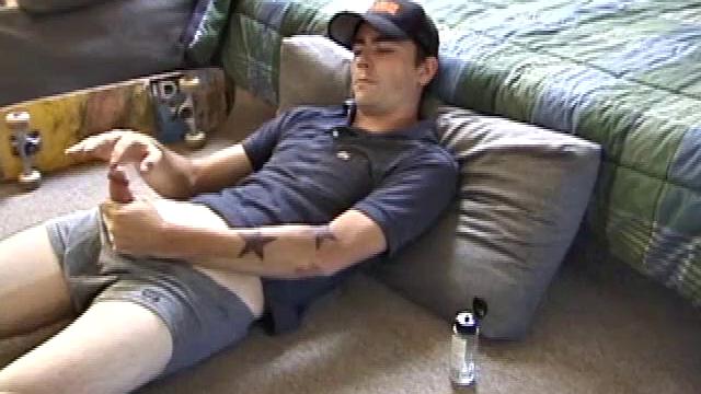 Dan gets down on the floor and starts watching a porn video. He goes right for his cock and plays with himself until he's boned up. Rolling the head with his palm, Dan lubes up his hot dick.