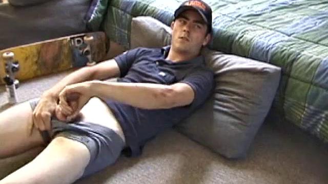 Dan gets down on the floor and starts watching a porn video. He goes right for his cock and plays with himself until he's boned up. Rolling the head with his palm, Dan lubes up his hot dick.