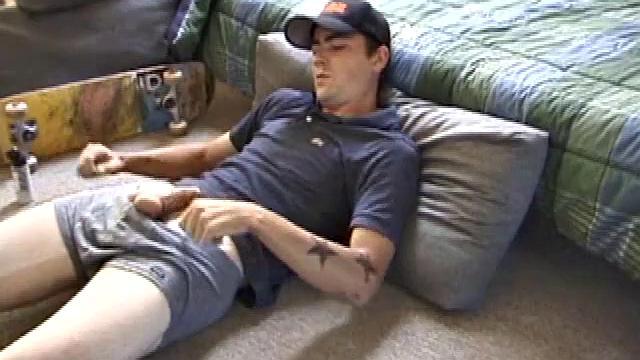 Dan gets down on the floor and starts watching a porn video. He goes right for his cock and plays with himself until he's boned up. Rolling the head with his palm, Dan lubes up his hot dick.