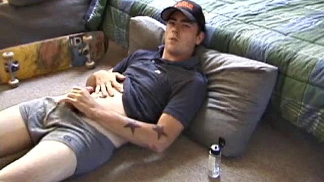 Dan gets down on the floor and starts watching a porn video. He goes right for his cock and plays with himself until he's boned up. Rolling the head with his palm, Dan lubes up his hot dick.