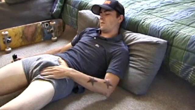 Dan gets down on the floor and starts watching a porn video. He goes right for his cock and plays with himself until he's boned up. Rolling the head with his palm, Dan lubes up his hot dick.