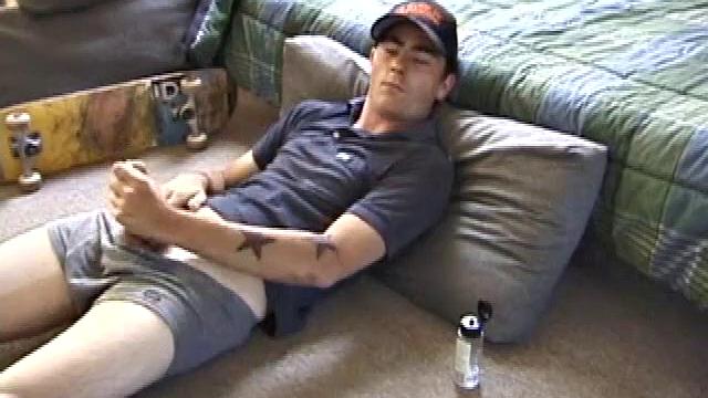 Dan gets down on the floor and starts watching a porn video. He goes right for his cock and plays with himself until he's boned up. Rolling the head with his palm, Dan lubes up his hot dick.