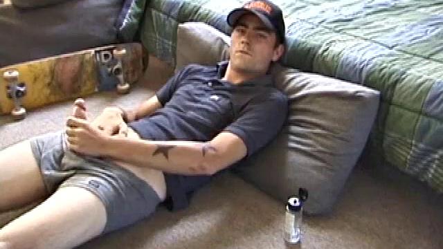 Dan gets down on the floor and starts watching a porn video. He goes right for his cock and plays with himself until he's boned up. Rolling the head with his palm, Dan lubes up his hot dick.