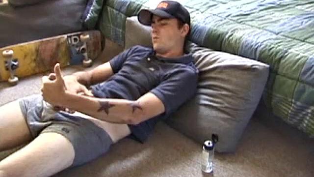 Dan gets down on the floor and starts watching a porn video. He goes right for his cock and plays with himself until he's boned up. Rolling the head with his palm, Dan lubes up his hot dick.