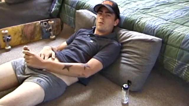 Dan gets down on the floor and starts watching a porn video. He goes right for his cock and plays with himself until he's boned up. Rolling the head with his palm, Dan lubes up his hot dick.