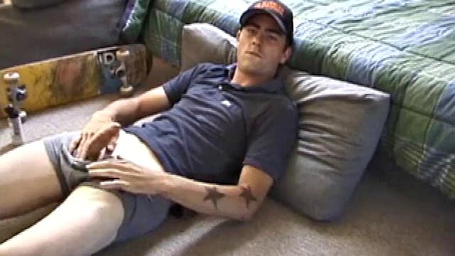 Dan gets down on the floor and starts watching a porn video. He goes right for his cock and plays with himself until he's boned up. Rolling the head with his palm, Dan lubes up his hot dick.