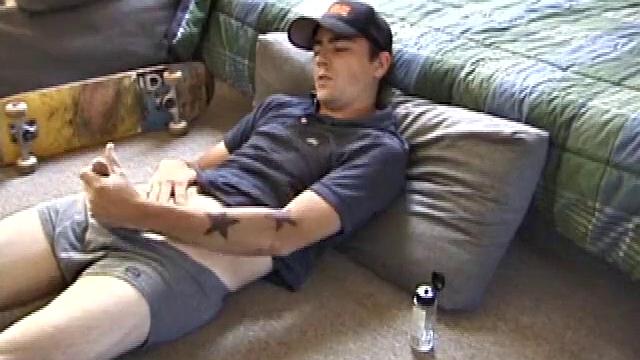 Dan gets down on the floor and starts watching a porn video. He goes right for his cock and plays with himself until he's boned up. Rolling the head with his palm, Dan lubes up his hot dick.