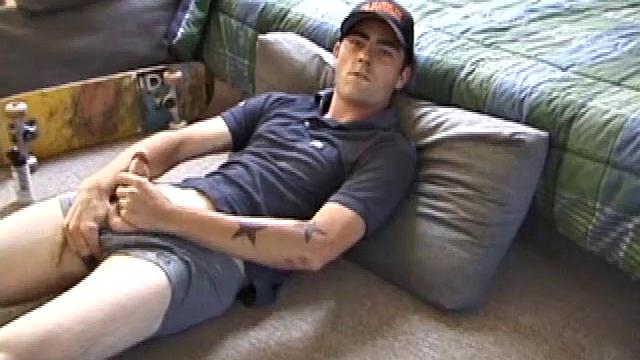 Dan gets down on the floor and starts watching a porn video. He goes right for his cock and plays with himself until he's boned up. Rolling the head with his palm, Dan lubes up his hot dick.