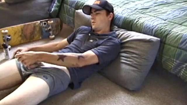 Dan gets down on the floor and starts watching a porn video. He goes right for his cock and plays with himself until he's boned up. Rolling the head with his palm, Dan lubes up his hot dick.