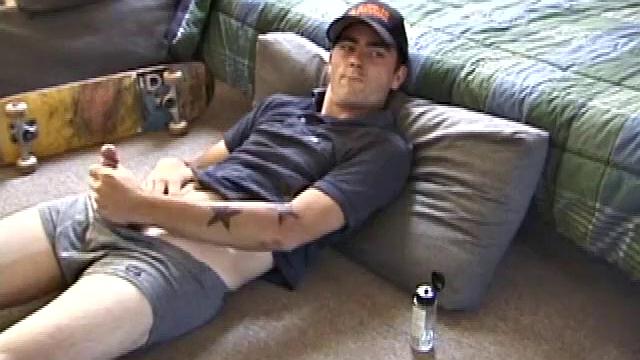 Dan gets down on the floor and starts watching a porn video. He goes right for his cock and plays with himself until he's boned up. Rolling the head with his palm, Dan lubes up his hot dick.