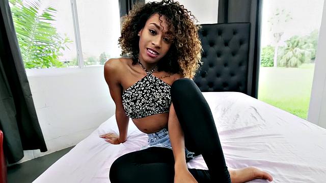 Curly-haired ebony babe with tattoos gets a hot fucking & facial in the bedroom