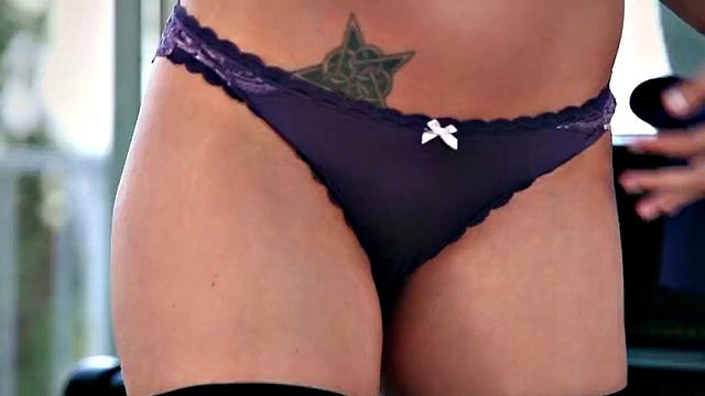 Curly-haired solo babe fingers her trimmed pussy in high heels and stockings