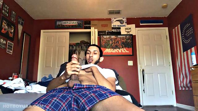 While watching a porn video, Brian kicks back, pushes his pants down and pulls his stiff dick out of the fly of his boxers. After a little stroking he pushes the underwear down to release his balls.