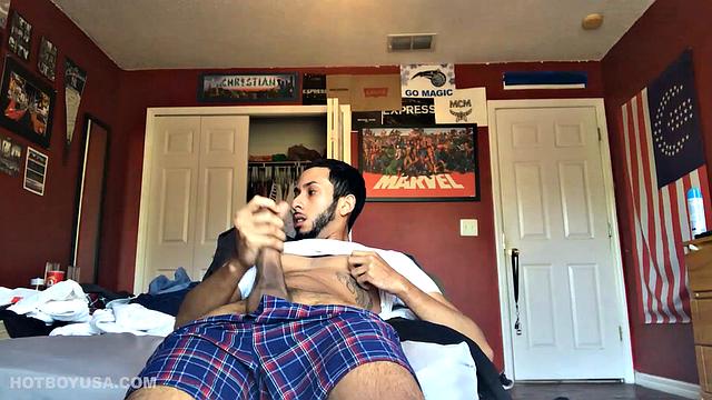 While watching a porn video, Brian kicks back, pushes his pants down and pulls his stiff dick out of the fly of his boxers. After a little stroking he pushes the underwear down to release his balls.