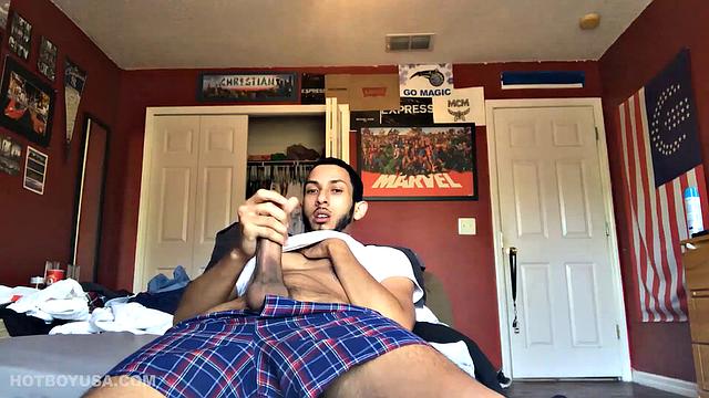 While watching a porn video, Brian kicks back, pushes his pants down and pulls his stiff dick out of the fly of his boxers. After a little stroking he pushes the underwear down to release his balls.