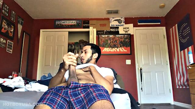 While watching a porn video, Brian kicks back, pushes his pants down and pulls his stiff dick out of the fly of his boxers. After a little stroking he pushes the underwear down to release his balls.